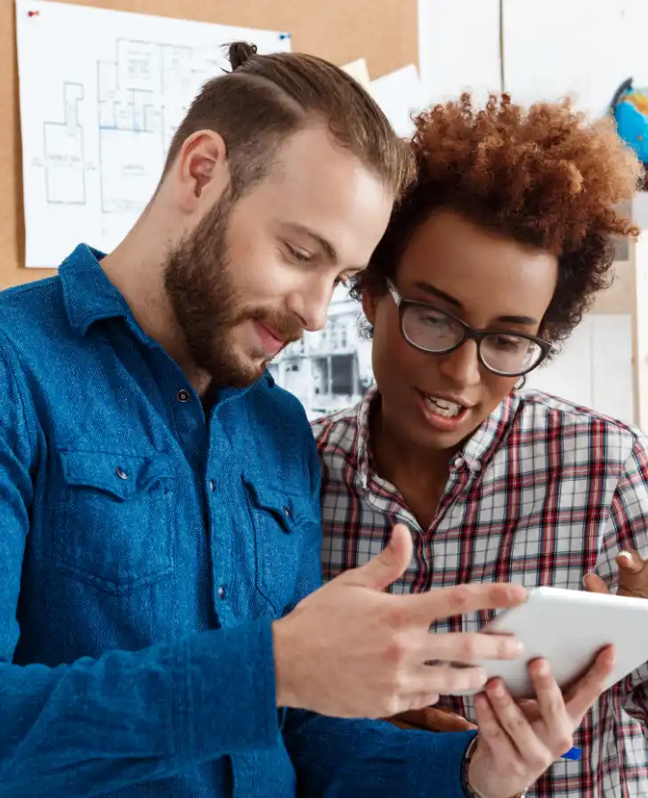 Two people double checking the application instructions